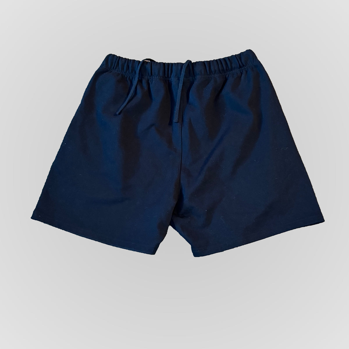 Dark blue drawstring shorts with elastic waistband and front graphic logo.