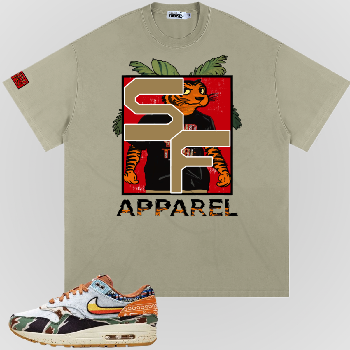 Greyish green Earning Stripes T-shirt with large front graphic and "APPAREL" text.